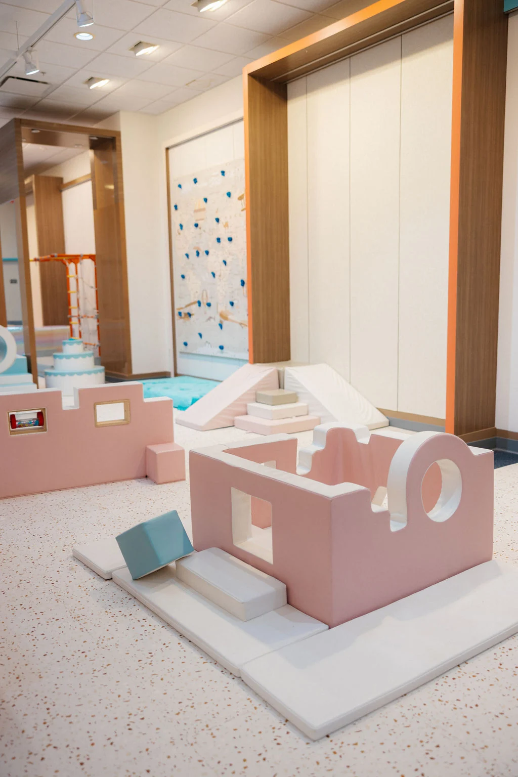 Pastel indoor play area with imaginative structures